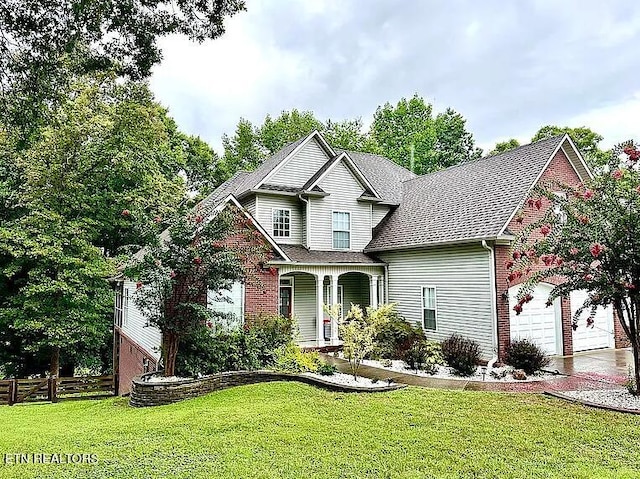 view of front of home with a porch, a garage, and a front yard