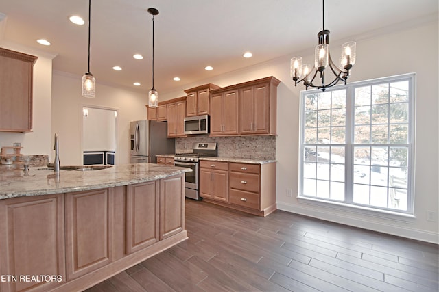 kitchen with decorative light fixtures, light stone countertops, stainless steel appliances, and a chandelier