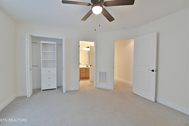 unfurnished bedroom featuring ceiling fan, a closet, and light carpet