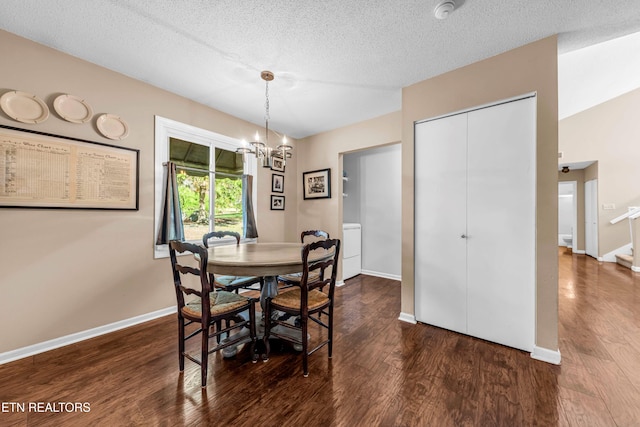 dining room featuring washer / dryer, dark hardwood / wood-style flooring, a textured ceiling, and an inviting chandelier