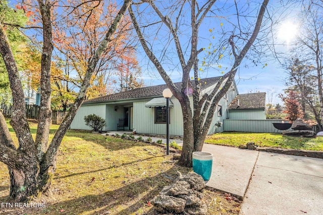 ranch-style house with a front lawn