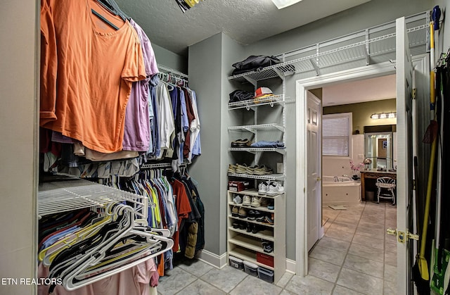 spacious closet with light tile patterned flooring