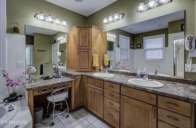 bathroom with tile patterned flooring, vanity, and a bathing tub