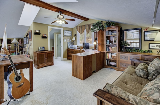 carpeted home office featuring a textured ceiling, vaulted ceiling with beams, ceiling fan, and a healthy amount of sunlight