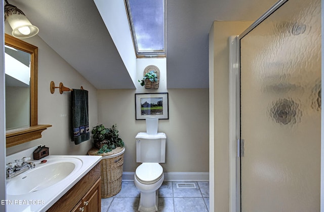 bathroom featuring vanity, lofted ceiling with skylight, tile patterned floors, toilet, and an enclosed shower