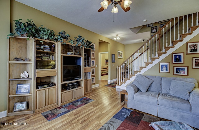 living room featuring ceiling fan and wood-type flooring