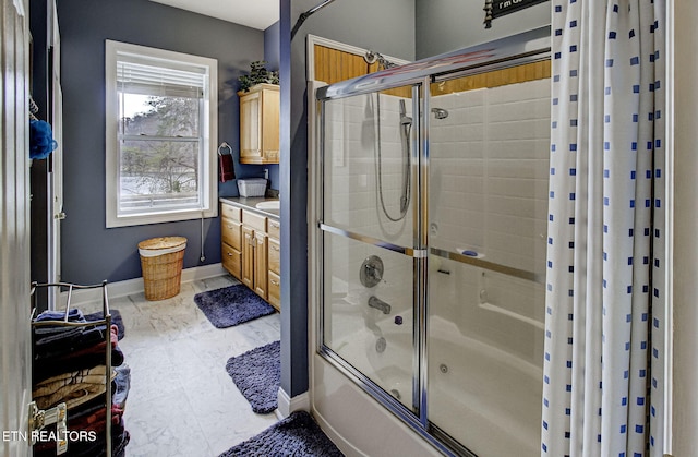 bathroom featuring vanity and shower / bath combination with glass door