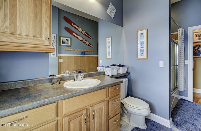 full bathroom featuring toilet, vanity, and combined bath / shower with glass door