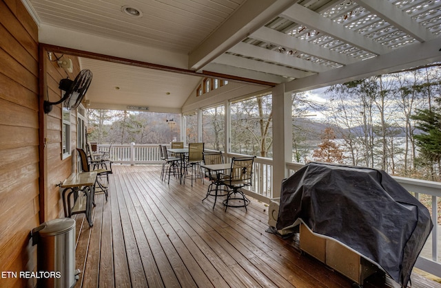 snow covered deck featuring a pergola and grilling area