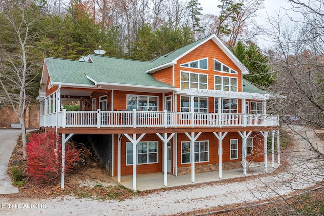 back of property featuring a wooden deck