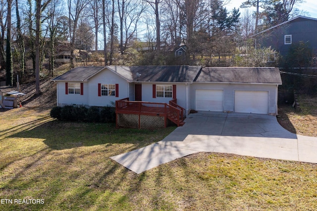 ranch-style home featuring a garage, a deck, a front lawn, and concrete driveway