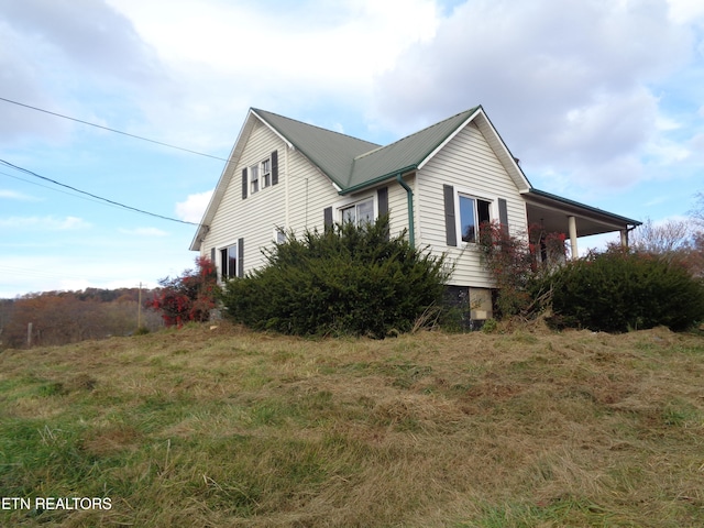 view of side of home featuring a lawn