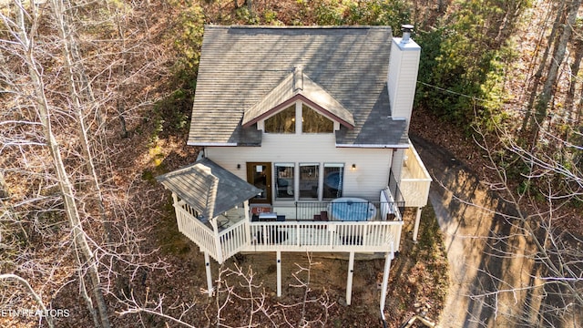 back of house featuring a wooden deck