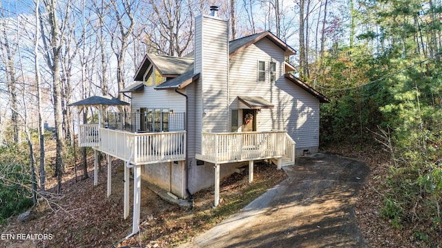 back of property with a wooden deck