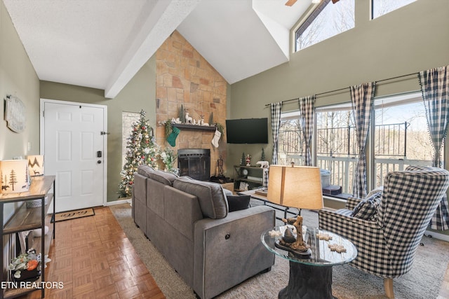 living room with a stone fireplace, ceiling fan, high vaulted ceiling, and parquet flooring