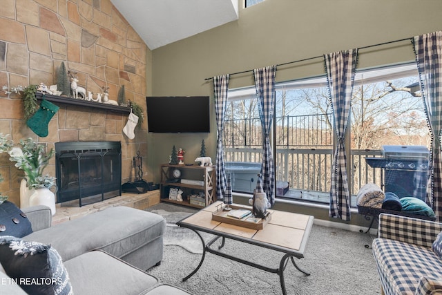 carpeted living room featuring plenty of natural light, a fireplace, and high vaulted ceiling