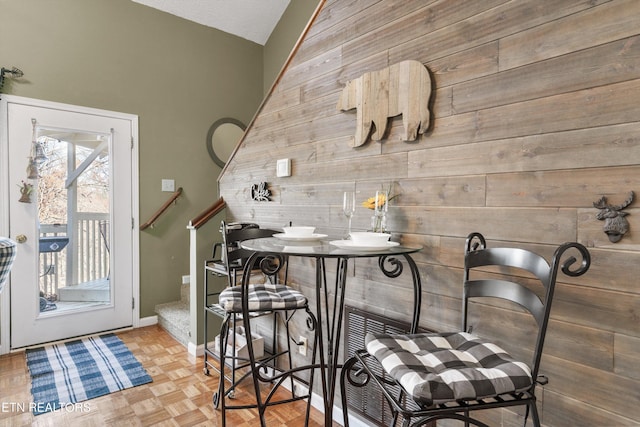 interior space with wooden walls and parquet flooring