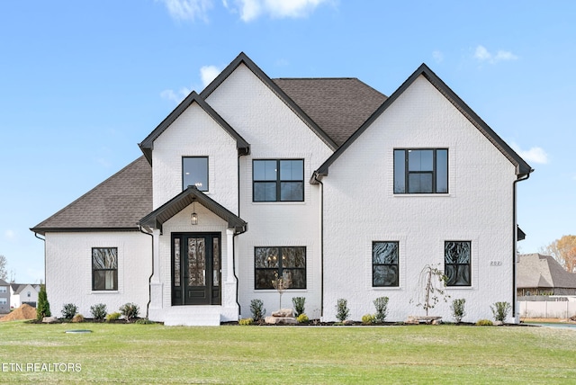 modern farmhouse style home with a front yard