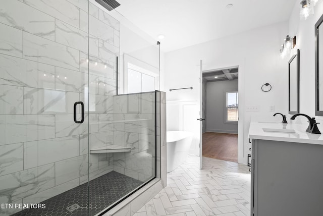 bathroom with plus walk in shower, vanity, and hardwood / wood-style flooring