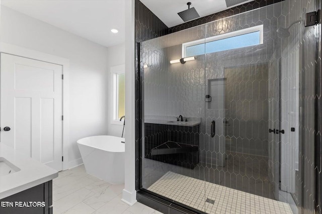 bathroom featuring vanity and separate shower and tub