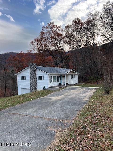 view of front of property featuring a porch and a garage