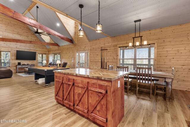 kitchen featuring wood walls, decorative light fixtures, and a center island