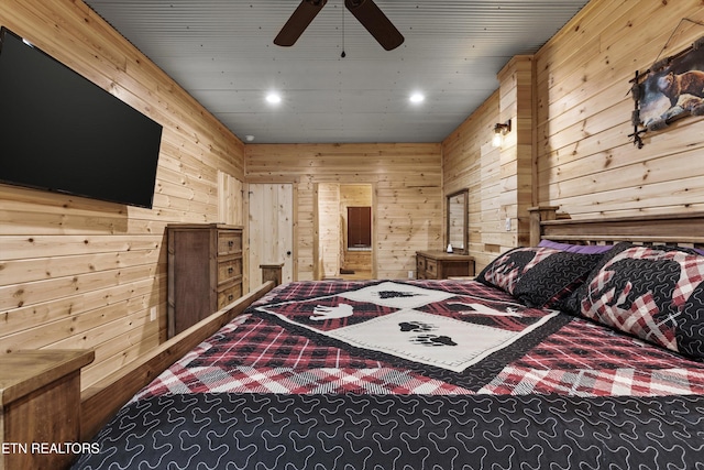 bedroom featuring ceiling fan and wood walls