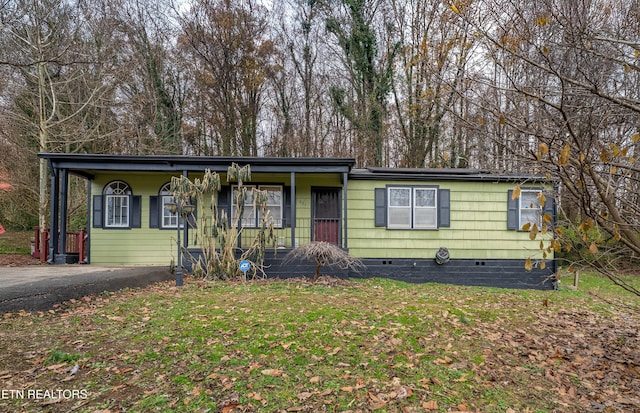 ranch-style house with a front yard and covered porch