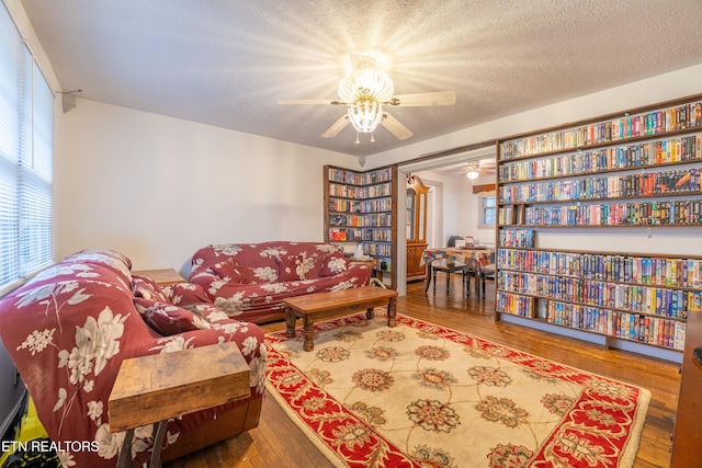 living area with a textured ceiling and hardwood / wood-style flooring