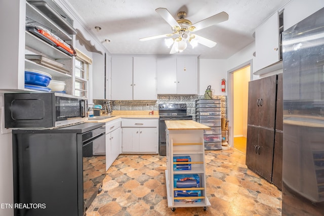 kitchen featuring butcher block counters, ceiling fan, black / electric stove, a textured ceiling, and white cabinets