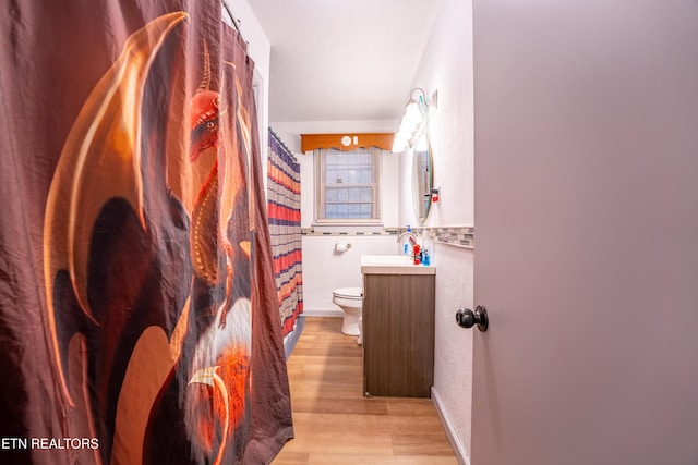 bathroom featuring hardwood / wood-style floors, vanity, and toilet