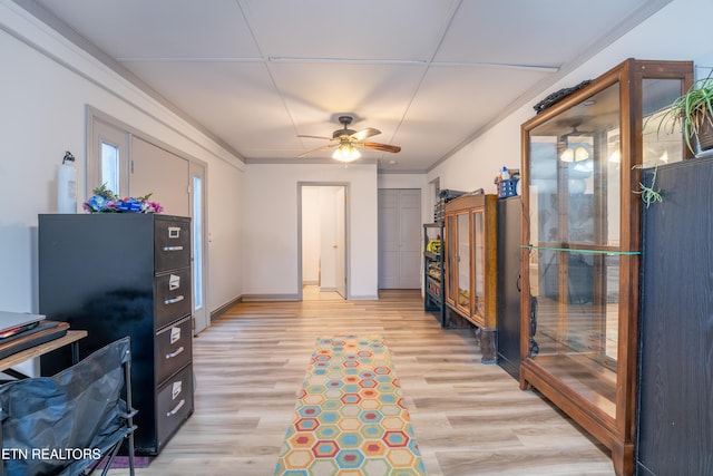 office space with ceiling fan, light hardwood / wood-style floors, and ornamental molding