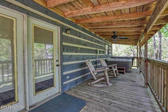 deck featuring ceiling fan and a hot tub