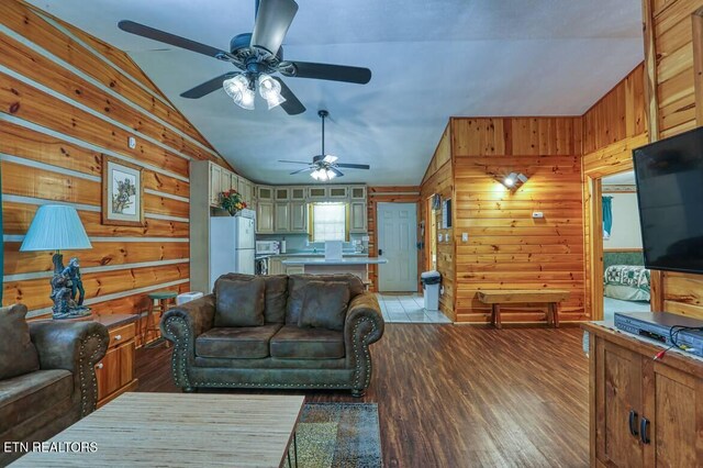 3018 Rivers Edge Dr, Cosby, TN 37722 - living area featuring vaulted ceiling, wooden walls, a ceiling fan, and light wood-style flooring