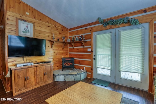 3018 Rivers Edge Dr, Cosby, TN 37722 - living room featuring lofted ceiling, a wood stove, dark wood-style floors, and wood walls
