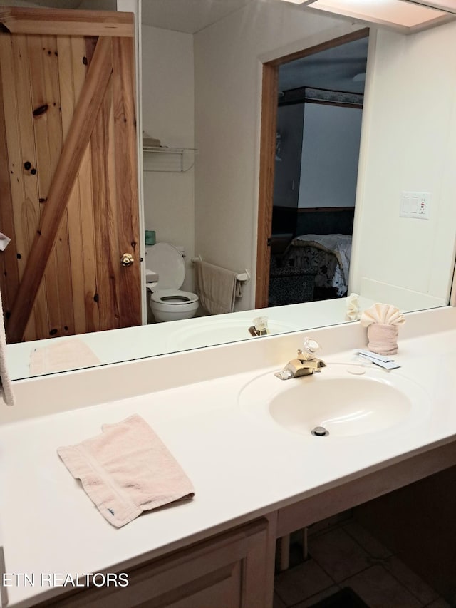 bathroom with tile patterned floors, vanity, and toilet