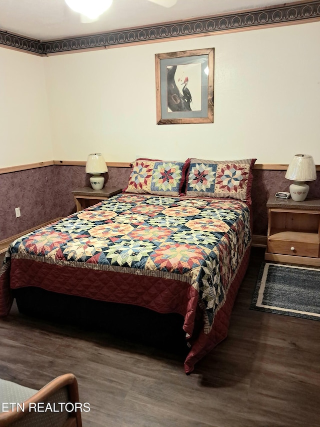 bedroom with dark hardwood / wood-style floors