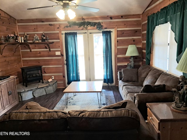 living room with vaulted ceiling, a wood stove, ceiling fan, and dark hardwood / wood-style floors