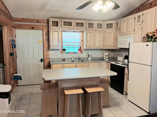 kitchen featuring white appliances, light tile patterned floors, a breakfast bar area, a center island, and lofted ceiling