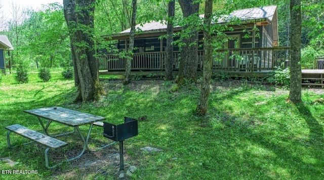 view of yard with a wooden deck and a sunroom