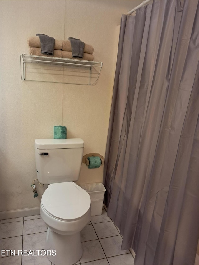 3018 Rivers Edge Dr, Cosby, TN 37722 - full bathroom featuring toilet, tile patterned flooring, curtained shower, and baseboards
