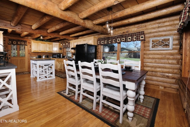 dining area featuring beamed ceiling, wooden ceiling, rustic walls, and light hardwood / wood-style flooring