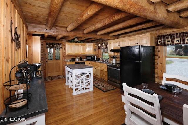 kitchen featuring black appliances, wood-type flooring, exhaust hood, and a wealth of natural light