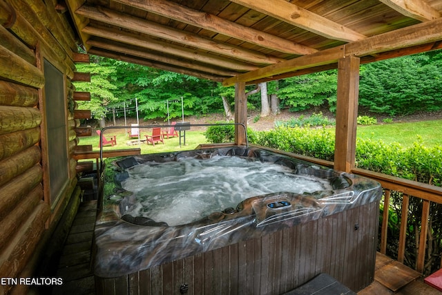 deck featuring a hot tub