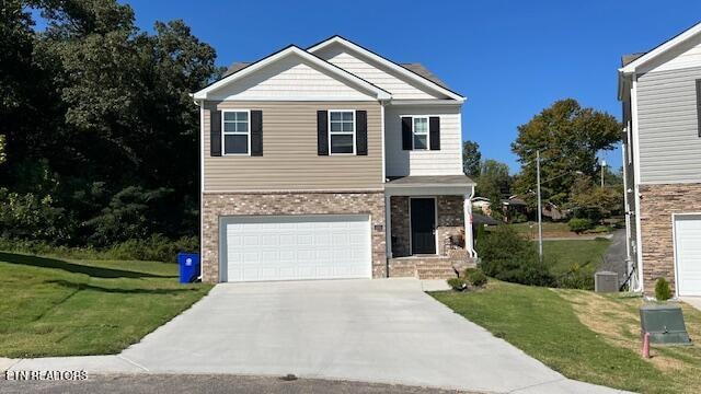 view of front of home with a garage and a front yard