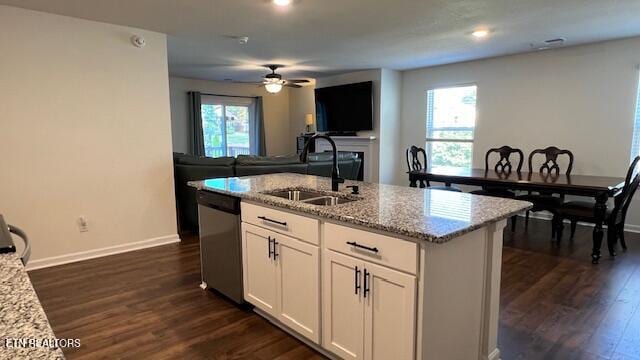 kitchen with dishwasher, white cabinets, plenty of natural light, and sink