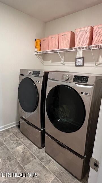 laundry room with washing machine and clothes dryer