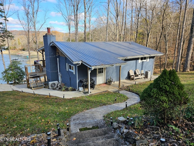 exterior space with a front lawn and a patio area