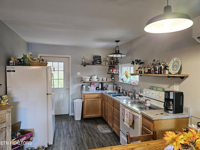 kitchen with dark hardwood / wood-style flooring, sink, pendant lighting, electric range, and white fridge