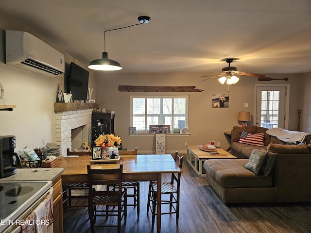 dining area with a wall mounted air conditioner, dark hardwood / wood-style floors, ceiling fan, and a fireplace